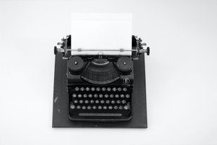 Antique typewriter with a blank sheet of paper inserted