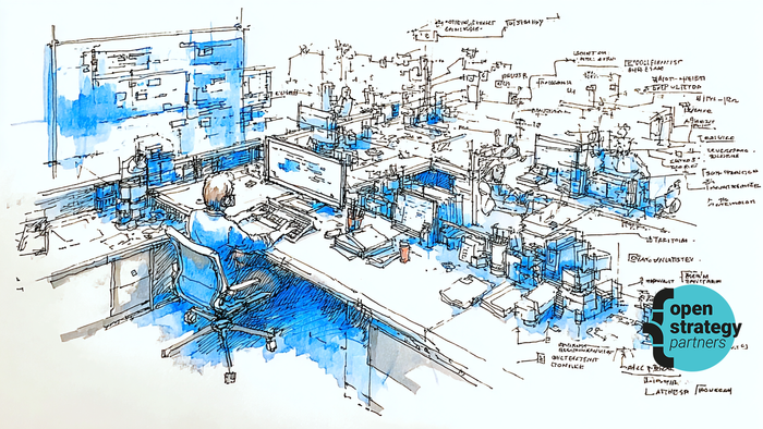 Person sitting at desk surrounded by lots of screens and technology